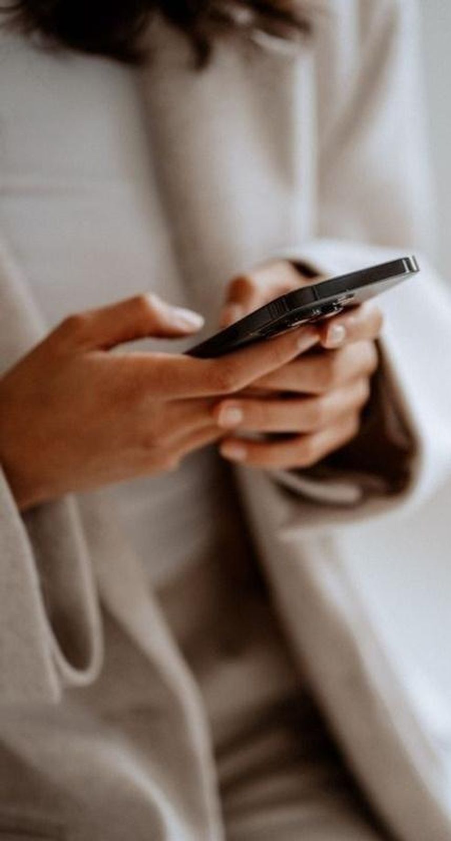 Close view of hands holding a phone.