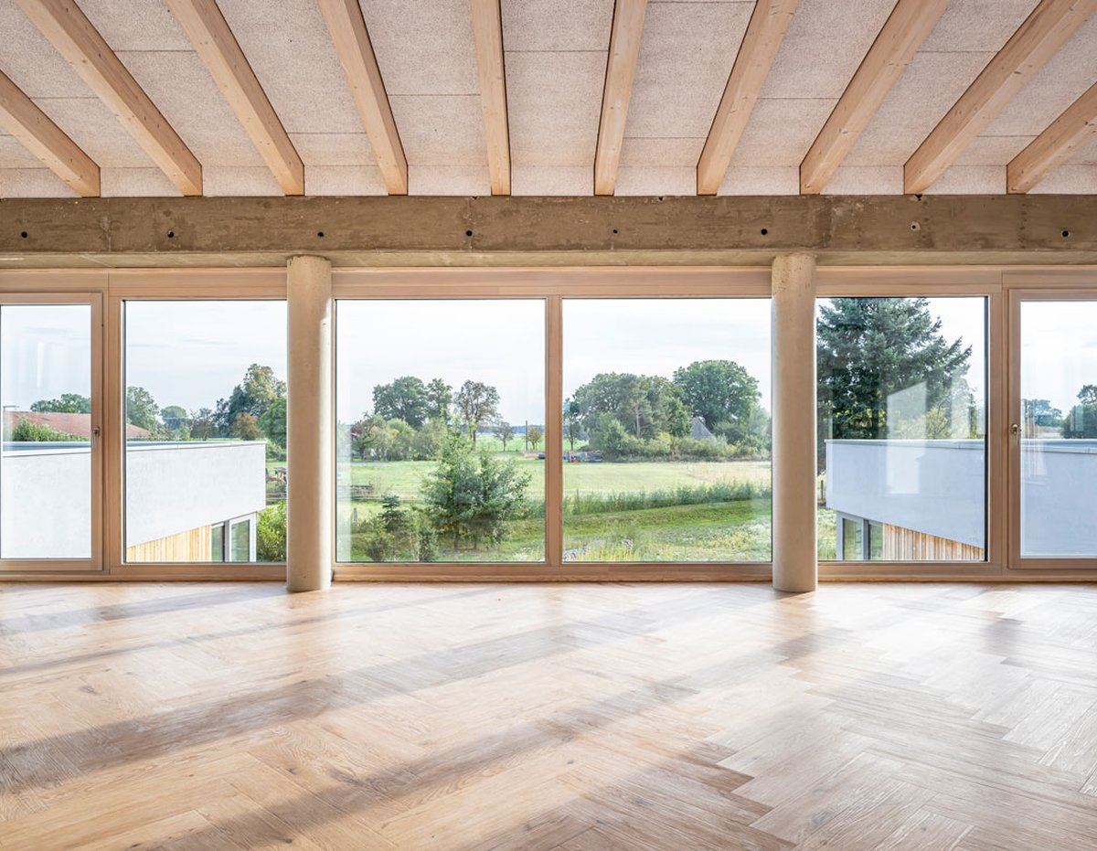 The seminar room at Friedrichshof, with wide windows opening onto the countryside.